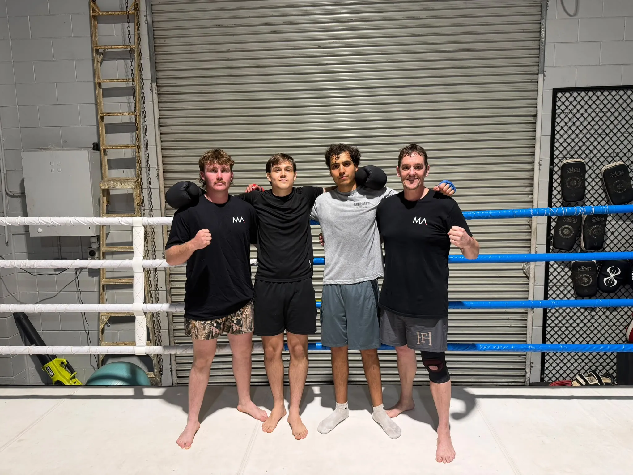 Left to right: Coach Jack Mills, Blake Grima, Amin Panetta and Coach John Boettcher in the ring at Innisfail